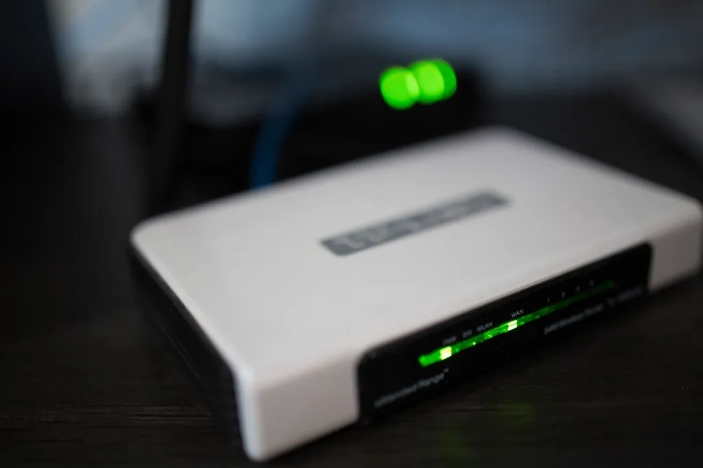 Home Wi-Fi router with its green status lights on, illustrating the ZYMINEX tips for smoother streaming on your home network